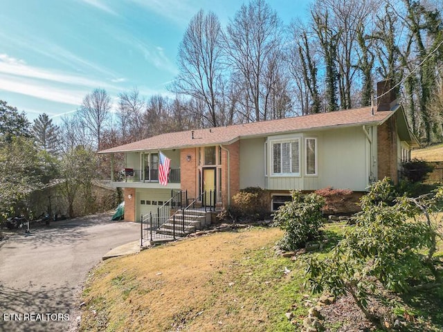 view of front of home with a garage and a front yard