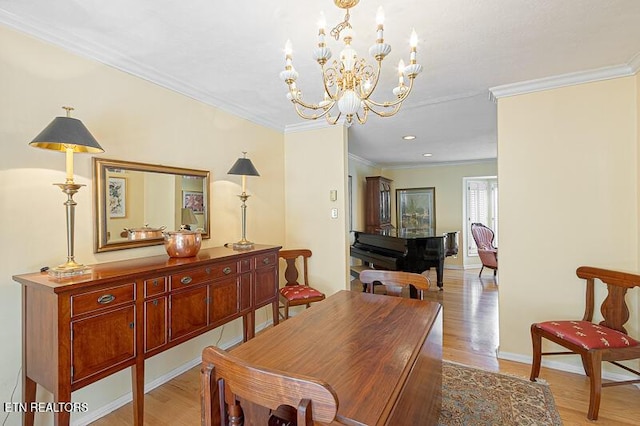 dining area with an inviting chandelier, crown molding, and light wood-type flooring