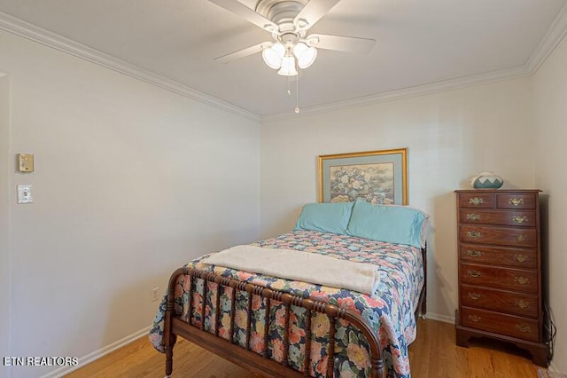 bedroom with light hardwood / wood-style flooring, ornamental molding, and ceiling fan