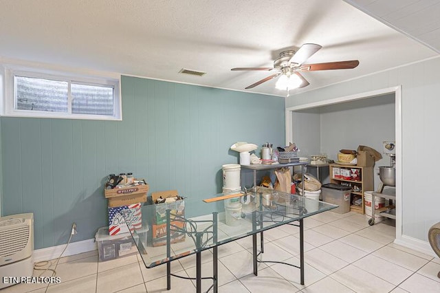 interior space featuring ceiling fan and a textured ceiling