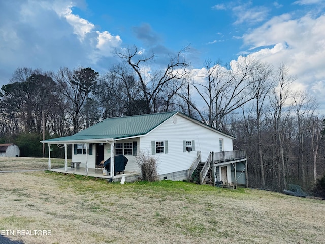 exterior space with a patio, a yard, and a deck