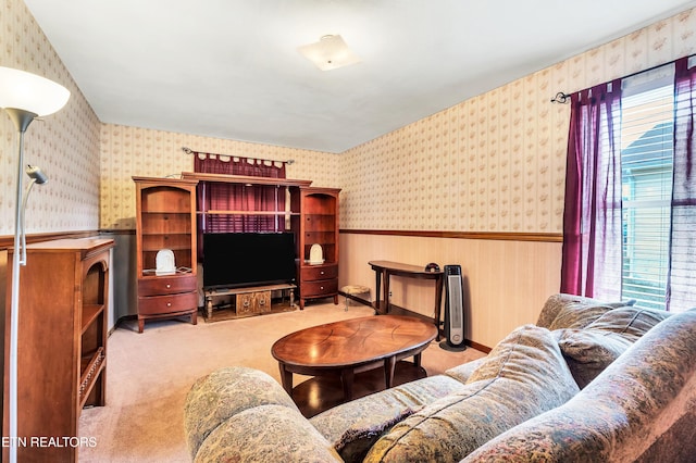 living area featuring light colored carpet, wainscoting, and wallpapered walls