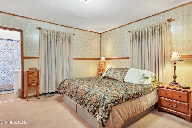 bedroom featuring wallpapered walls, crown molding, and light colored carpet