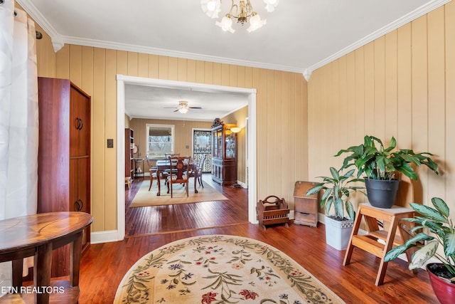 interior space with baseboards, ornamental molding, dark wood-type flooring, and a notable chandelier