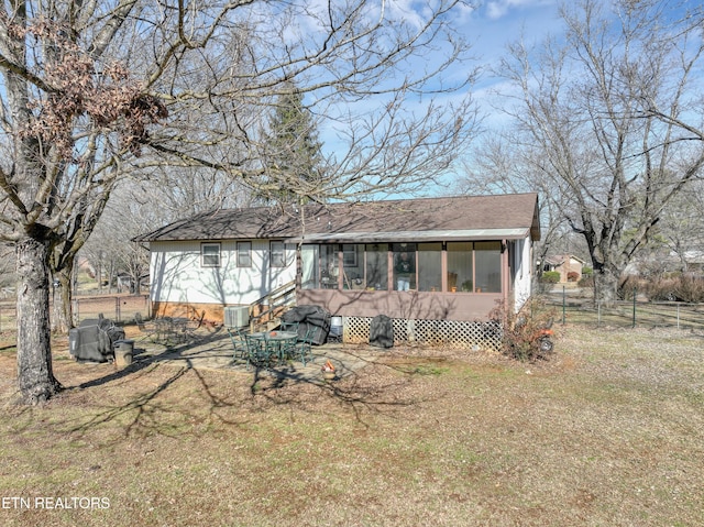 view of front of property with a sunroom and a front yard