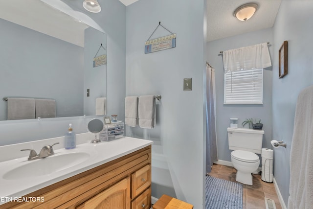 bathroom with vanity, tile patterned floors, a textured ceiling, and toilet