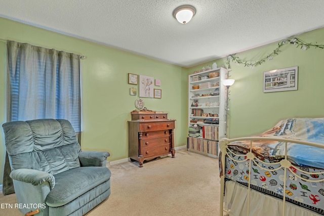 bedroom with light carpet and a textured ceiling