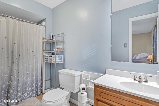 bathroom featuring vanity, toilet, and walk in shower