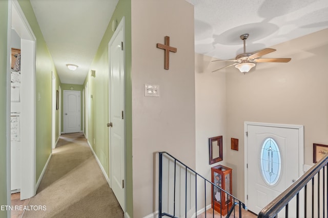 hallway featuring light colored carpet