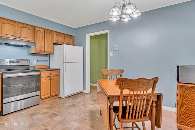 kitchen featuring white fridge, a chandelier, stainless steel electric range, and pendant lighting