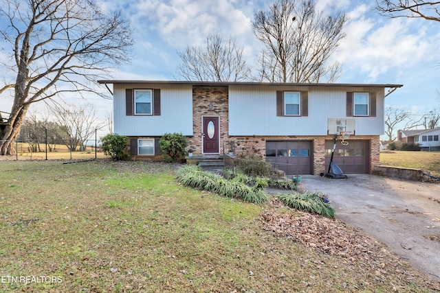 raised ranch with a garage and a front yard