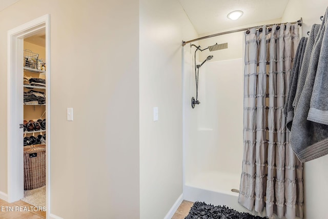 bathroom with tile patterned floors and a shower