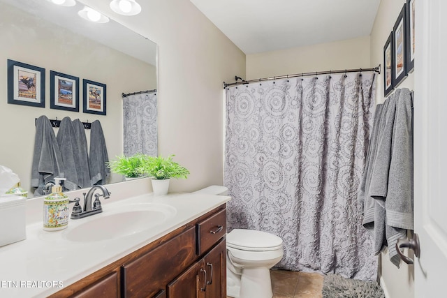 bathroom with vanity, tile patterned floors, and toilet