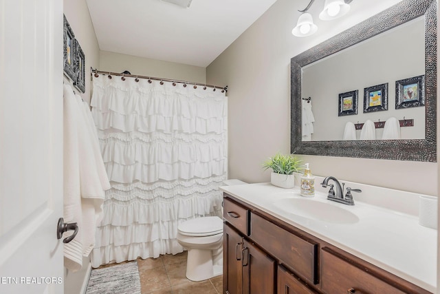 bathroom with vanity, toilet, and tile patterned flooring