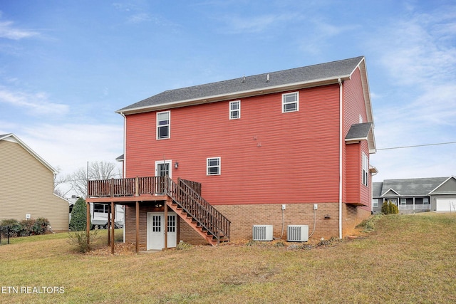 rear view of property featuring a wooden deck, a yard, and central AC unit