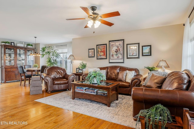 living room featuring ceiling fan and light wood-type flooring