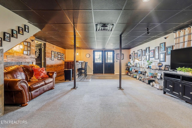 interior space featuring a drop ceiling and carpet floors