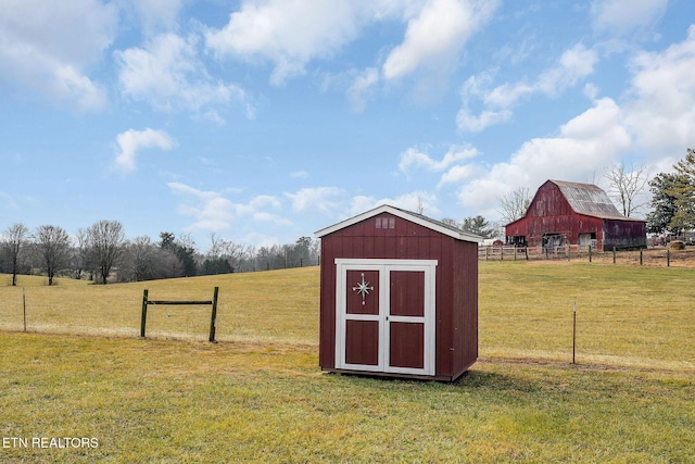 view of outbuilding featuring a yard and a rural view