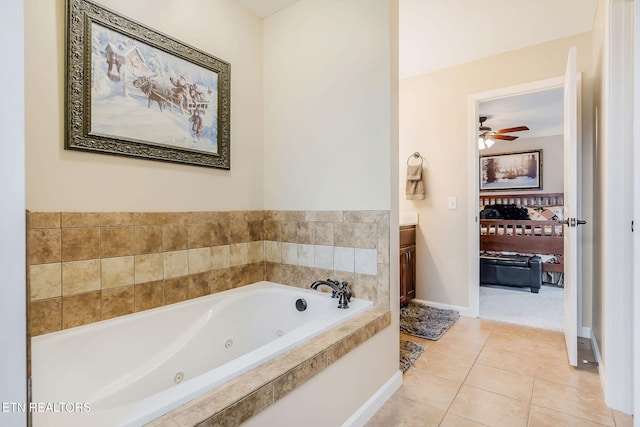 bathroom with vanity, a relaxing tiled tub, tile patterned floors, and ceiling fan