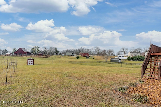 view of yard featuring a rural view and a shed