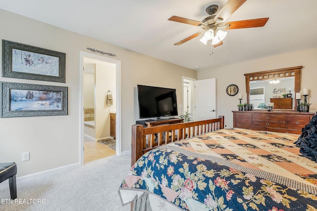 carpeted bedroom with ceiling fan and ensuite bath