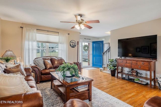 living room featuring wood-type flooring and ceiling fan