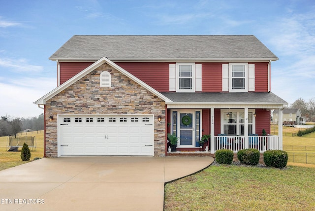 view of front of property with a garage, covered porch, and a front lawn