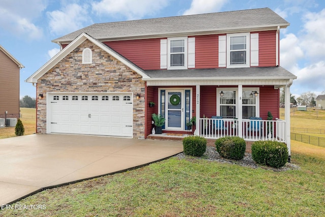 view of front of property featuring a garage, central AC, a front lawn, and a porch