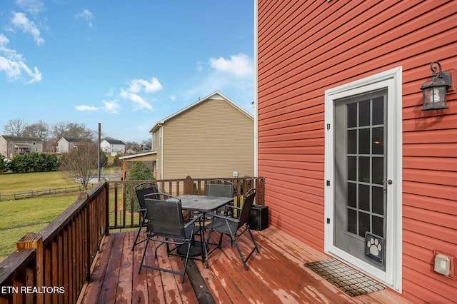 wooden deck featuring a yard