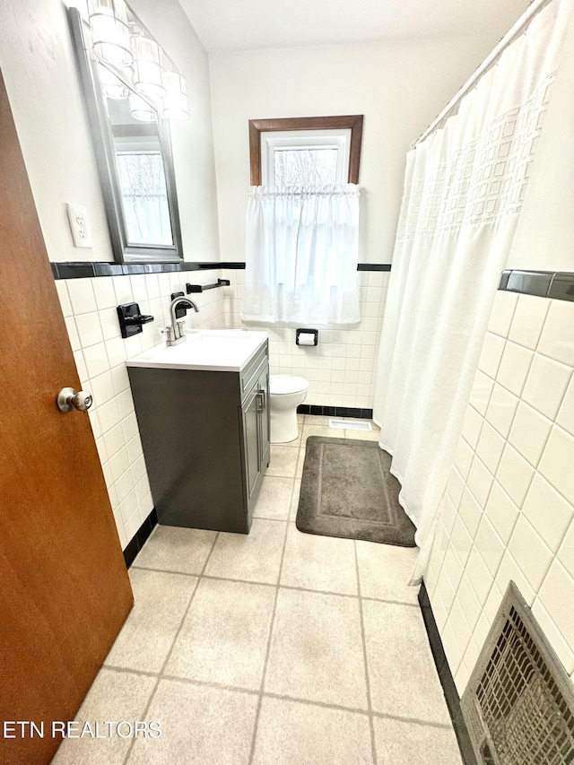 bathroom featuring vanity, tile walls, curtained shower, and toilet