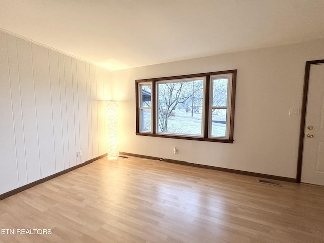 spare room with light hardwood / wood-style flooring