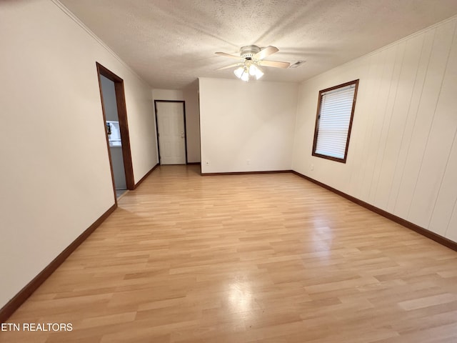 unfurnished room with ceiling fan, ornamental molding, light hardwood / wood-style floors, and a textured ceiling