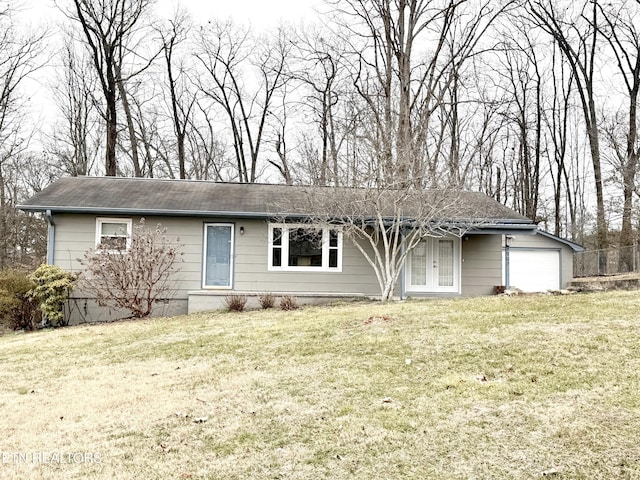 ranch-style home with a garage and a front lawn