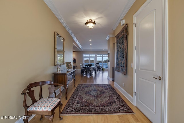 corridor featuring ornamental molding and light wood-type flooring