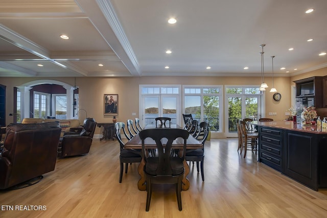 dining room featuring ornamental molding, plenty of natural light, light hardwood / wood-style floors, and ornate columns