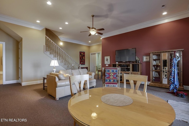 dining area with crown molding, carpet, and ceiling fan