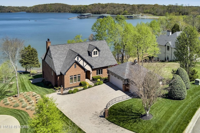 birds eye view of property with a water view