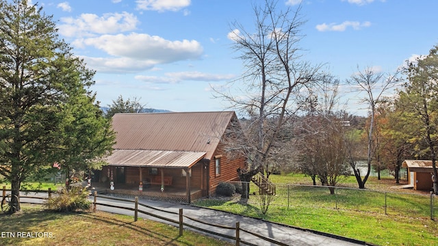 exterior space featuring an outdoor structure and a front yard