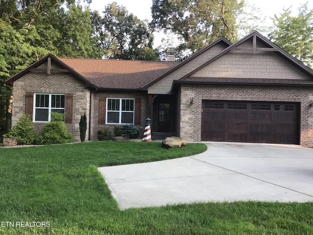 craftsman house featuring a garage and a front yard