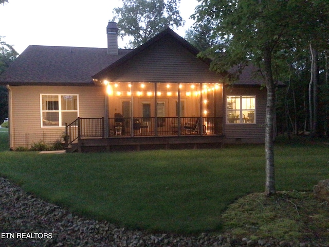 back of house featuring a yard and a deck