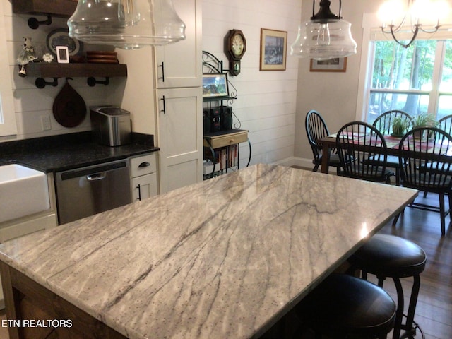 kitchen with dishwasher, white cabinets, and light stone counters