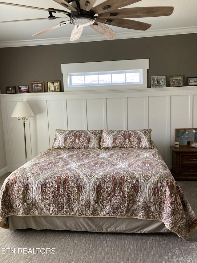 carpeted bedroom featuring ceiling fan and ornamental molding