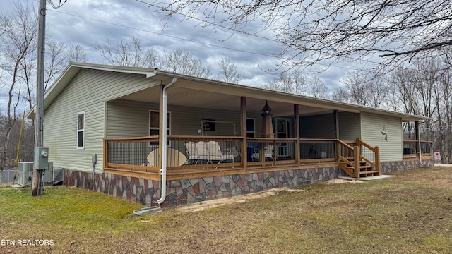 exterior space featuring a yard and ceiling fan