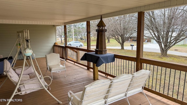 wooden deck featuring a yard