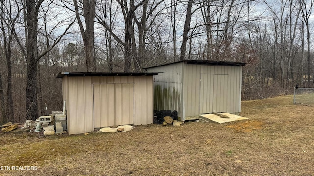 view of outbuilding featuring a yard