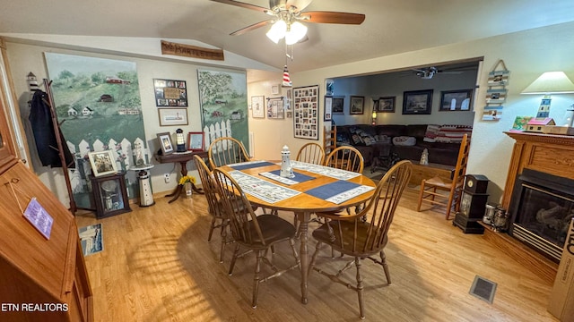 dining area with vaulted ceiling, light hardwood / wood-style floors, and ceiling fan