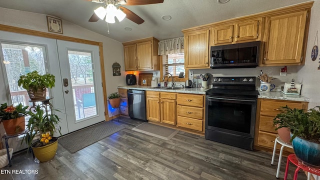 kitchen with vaulted ceiling, sink, ceiling fan, black appliances, and dark wood-type flooring