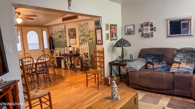 living room featuring lofted ceiling, hardwood / wood-style flooring, and ceiling fan