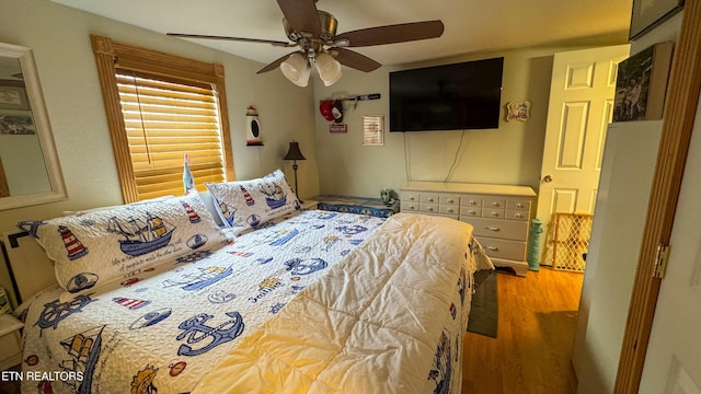 bedroom featuring hardwood / wood-style floors and ceiling fan