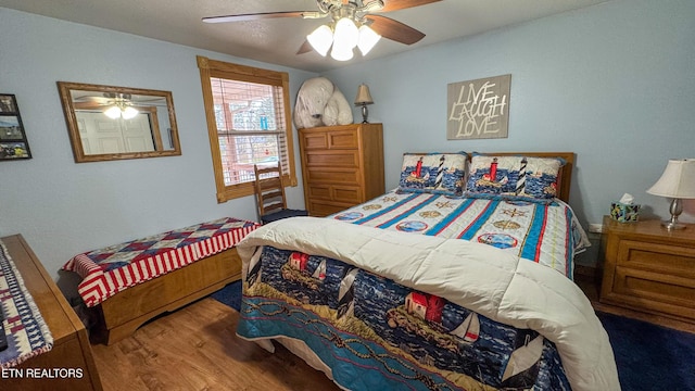 bedroom featuring wood-type flooring and ceiling fan